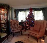 Living room with Christmas tree, wingback chairs and holiday decorations